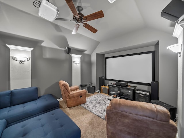 carpeted home theater with ceiling fan and vaulted ceiling