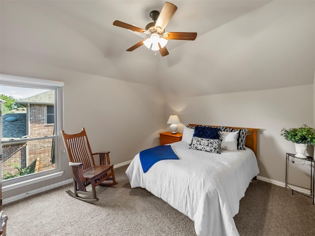 carpeted bedroom featuring ceiling fan, multiple windows, and vaulted ceiling