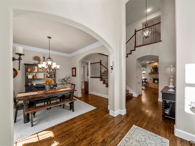 dining space featuring a notable chandelier, dark hardwood / wood-style flooring, and ornamental molding