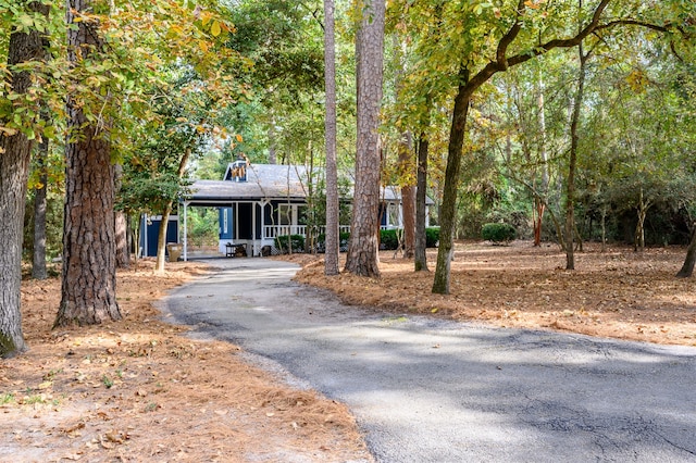 view of front facade with aphalt driveway and an attached carport