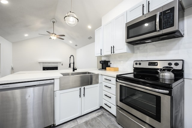 kitchen featuring stainless steel appliances, pendant lighting, light countertops, and white cabinetry