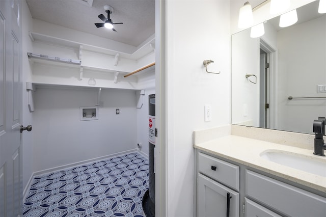 bathroom featuring ceiling fan, a textured ceiling, and vanity