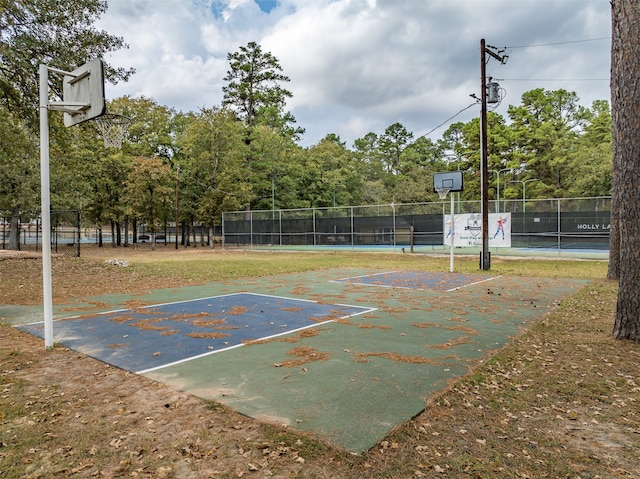 view of basketball court featuring community basketball court and fence