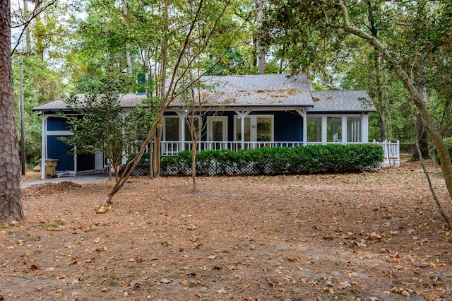 rear view of property with a porch