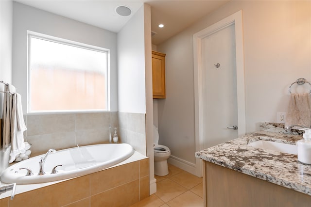 bathroom with toilet, a relaxing tiled tub, a healthy amount of sunlight, and vanity