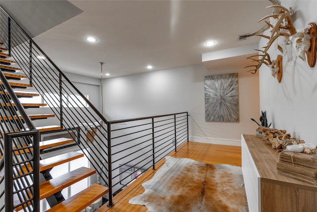 staircase featuring hardwood / wood-style flooring