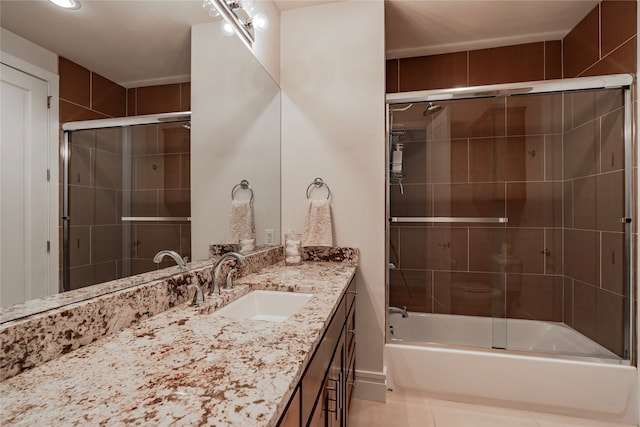 bathroom with vanity, tile patterned floors, and combined bath / shower with glass door