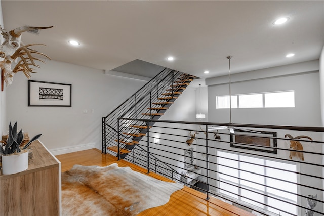 staircase with wood-type flooring