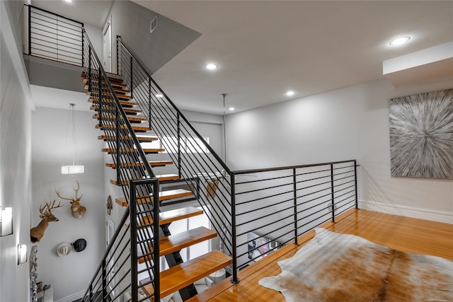 stairs with hardwood / wood-style floors