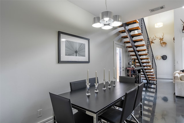 dining area with an inviting chandelier