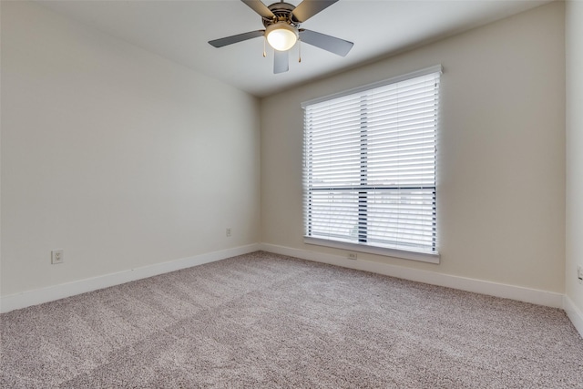 carpeted empty room featuring plenty of natural light and ceiling fan