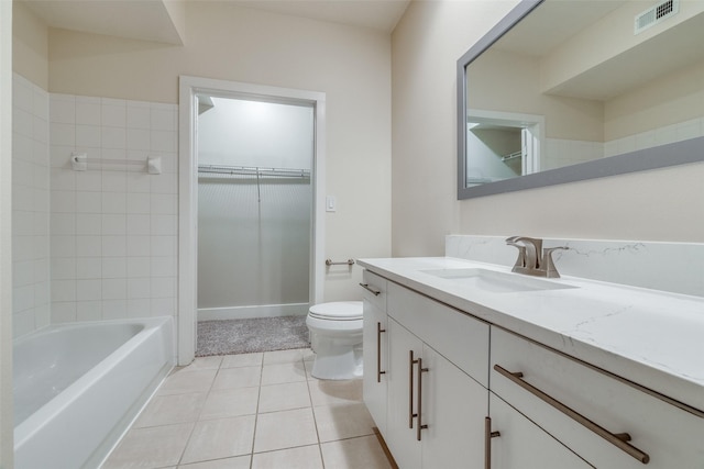 bathroom with tile patterned flooring, vanity, and toilet