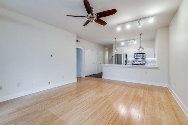 unfurnished living room featuring light hardwood / wood-style floors and ceiling fan