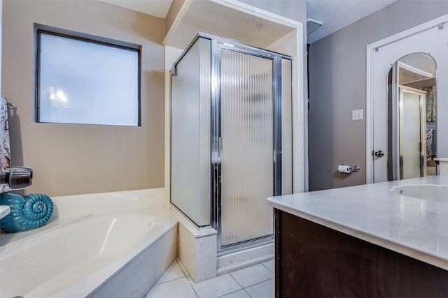 bathroom featuring vanity, plus walk in shower, and tile patterned floors