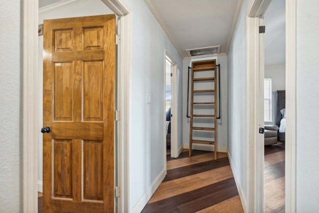 hallway featuring a wealth of natural light, hardwood / wood-style flooring, and crown molding