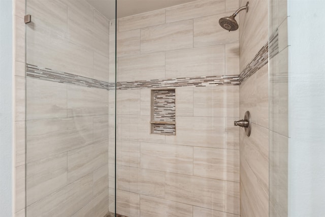 bathroom with tiled shower