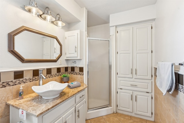 bathroom featuring tile walls, vanity, an enclosed shower, and tile patterned flooring