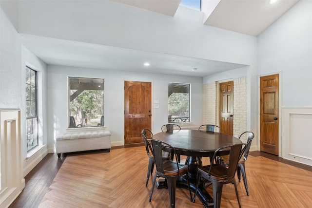 dining area featuring a wealth of natural light and light parquet floors