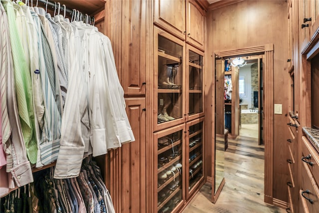 walk in closet featuring light hardwood / wood-style flooring