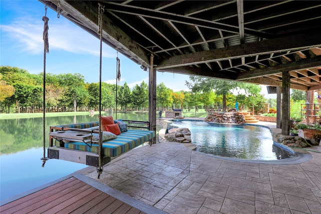 view of dock with a patio and a water view