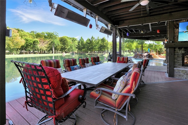 wooden deck featuring a water view and ceiling fan