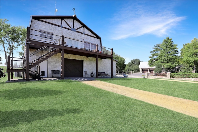 rear view of property with a lawn and a garage