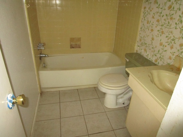 full bathroom featuring tile patterned flooring, tiled shower / bath combo, toilet, and vanity