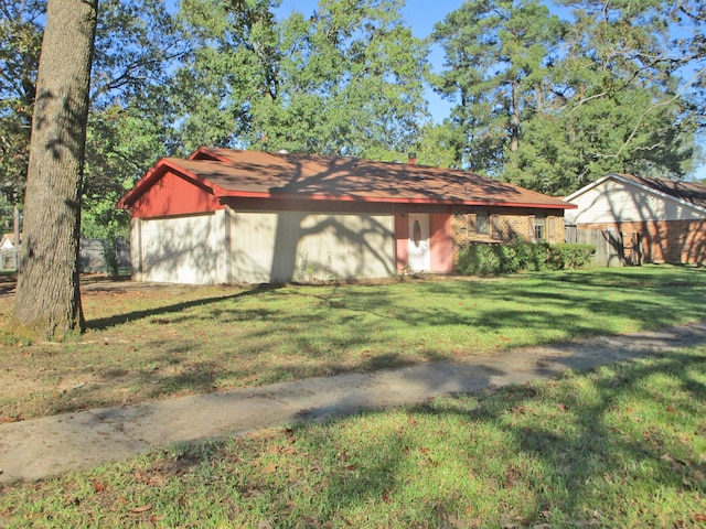 exterior space featuring an outbuilding and a front yard