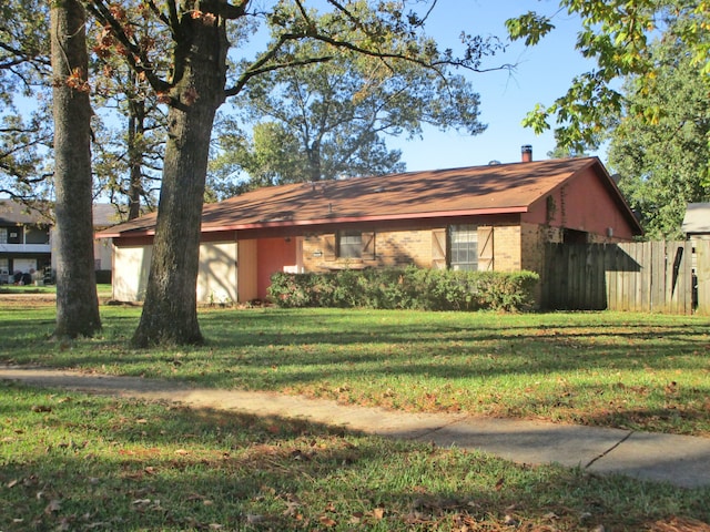 ranch-style home with a front lawn