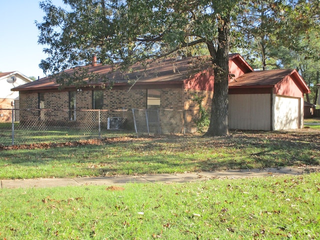 rear view of property with a lawn and a garage