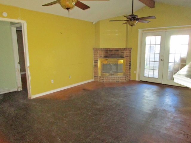 unfurnished living room with vaulted ceiling with beams, ceiling fan, french doors, and a brick fireplace