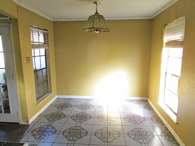 unfurnished dining area with tile patterned floors, a healthy amount of sunlight, and ornamental molding