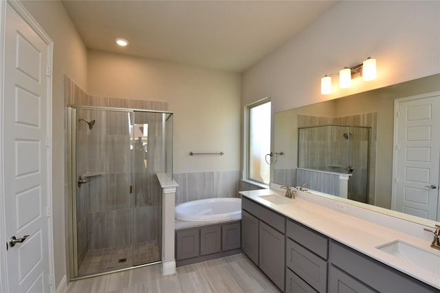 bathroom with tile patterned floors, vanity, and separate shower and tub