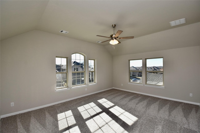 carpeted spare room featuring ceiling fan and vaulted ceiling