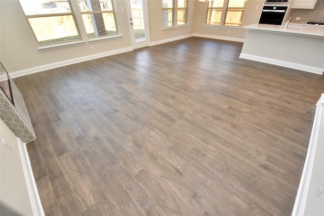 unfurnished living room with dark hardwood / wood-style floors