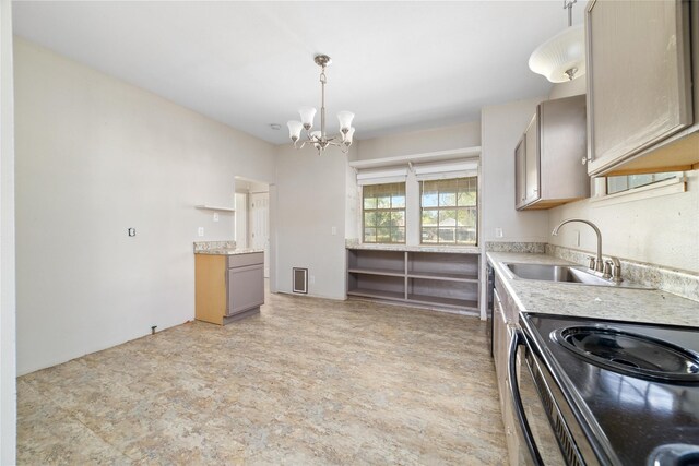 kitchen with black range with electric stovetop, light countertops, an inviting chandelier, and a sink