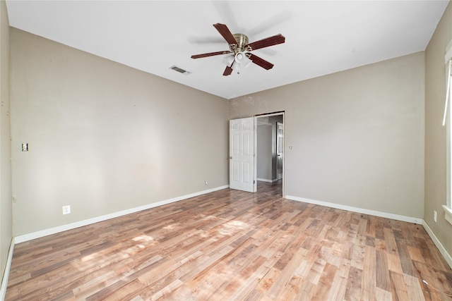 unfurnished bedroom featuring a closet, light wood-type flooring, visible vents, ceiling fan, and baseboards