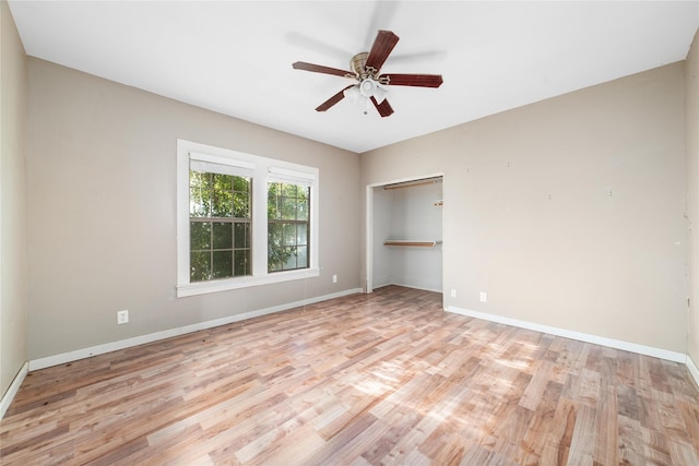 unfurnished bedroom featuring baseboards, light wood-style floors, and a closet