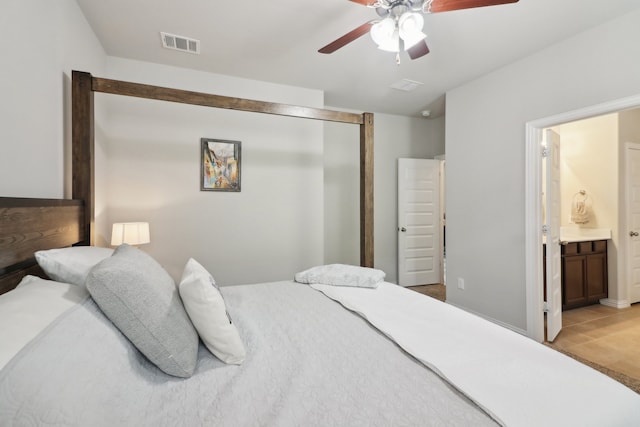 bedroom with ensuite bath, tile patterned flooring, and ceiling fan