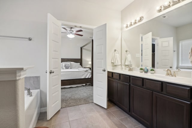 bathroom featuring vanity, tile patterned floors, a washtub, and ceiling fan