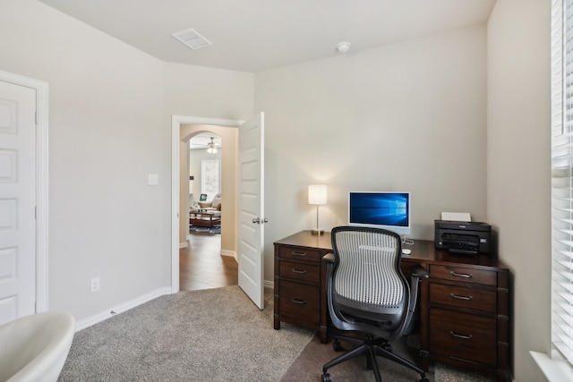 home office with light carpet and ceiling fan