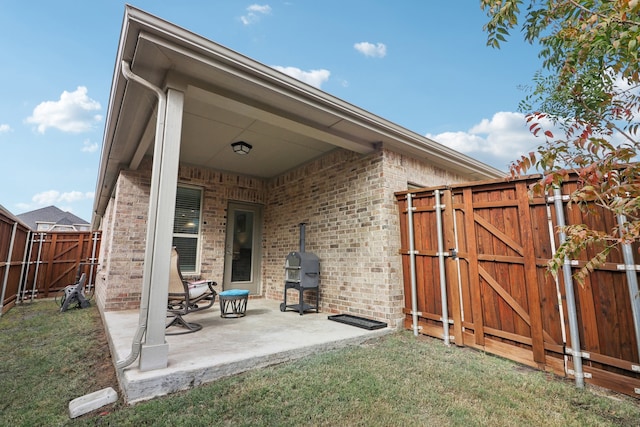 rear view of house featuring a patio area and a yard