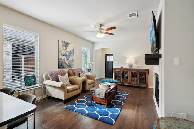 living room featuring dark hardwood / wood-style floors and ceiling fan