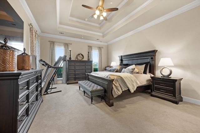 carpeted bedroom with ceiling fan, a raised ceiling, and ornamental molding