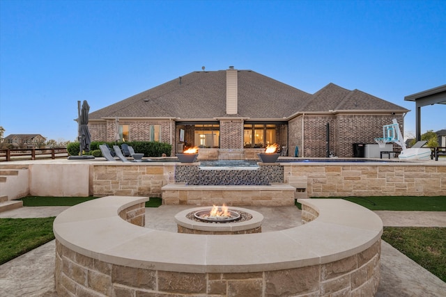 exterior space featuring an outdoor fire pit