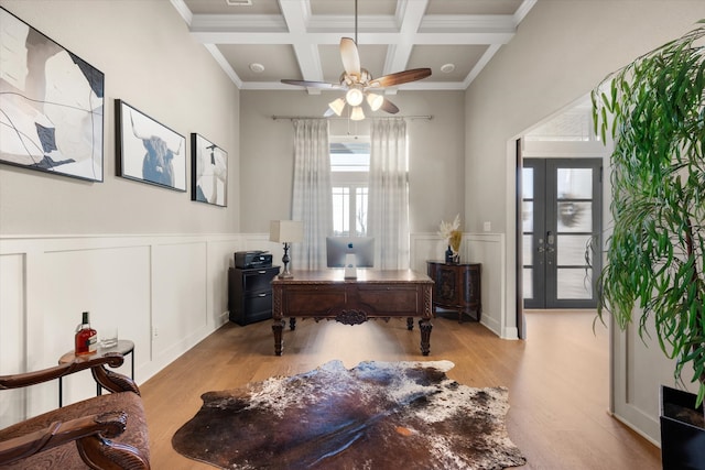 home office with beam ceiling, ceiling fan, light hardwood / wood-style flooring, french doors, and coffered ceiling