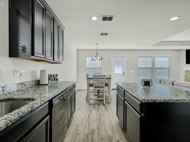 kitchen with light hardwood / wood-style floors, dishwasher, light stone counters, and a kitchen island