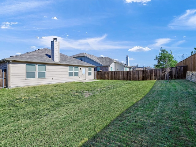 back of house featuring a lawn