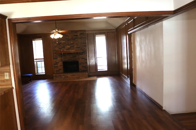 unfurnished living room featuring a fireplace, plenty of natural light, and dark hardwood / wood-style floors