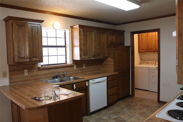 kitchen featuring a textured ceiling, separate washer and dryer, ornamental molding, sink, and white appliances